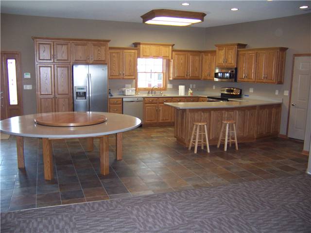 Red oak cabinets - Raised panel doors and side panels - Standard overlay style - Corian solid surface countertops and tabletop